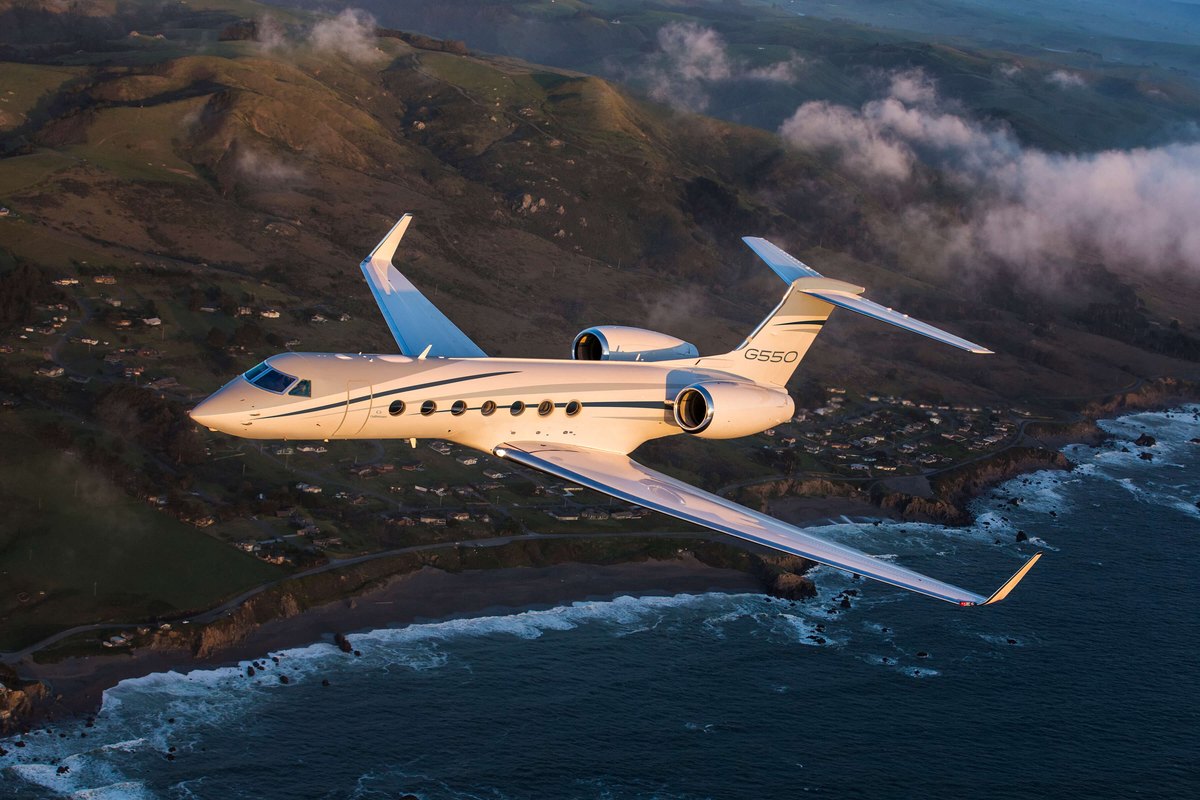 Gulfstream G550 heavy jet in flight over the coast