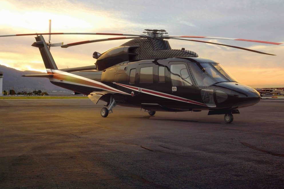 Sikorsky S-76 helicopter on the ramp at sunset
