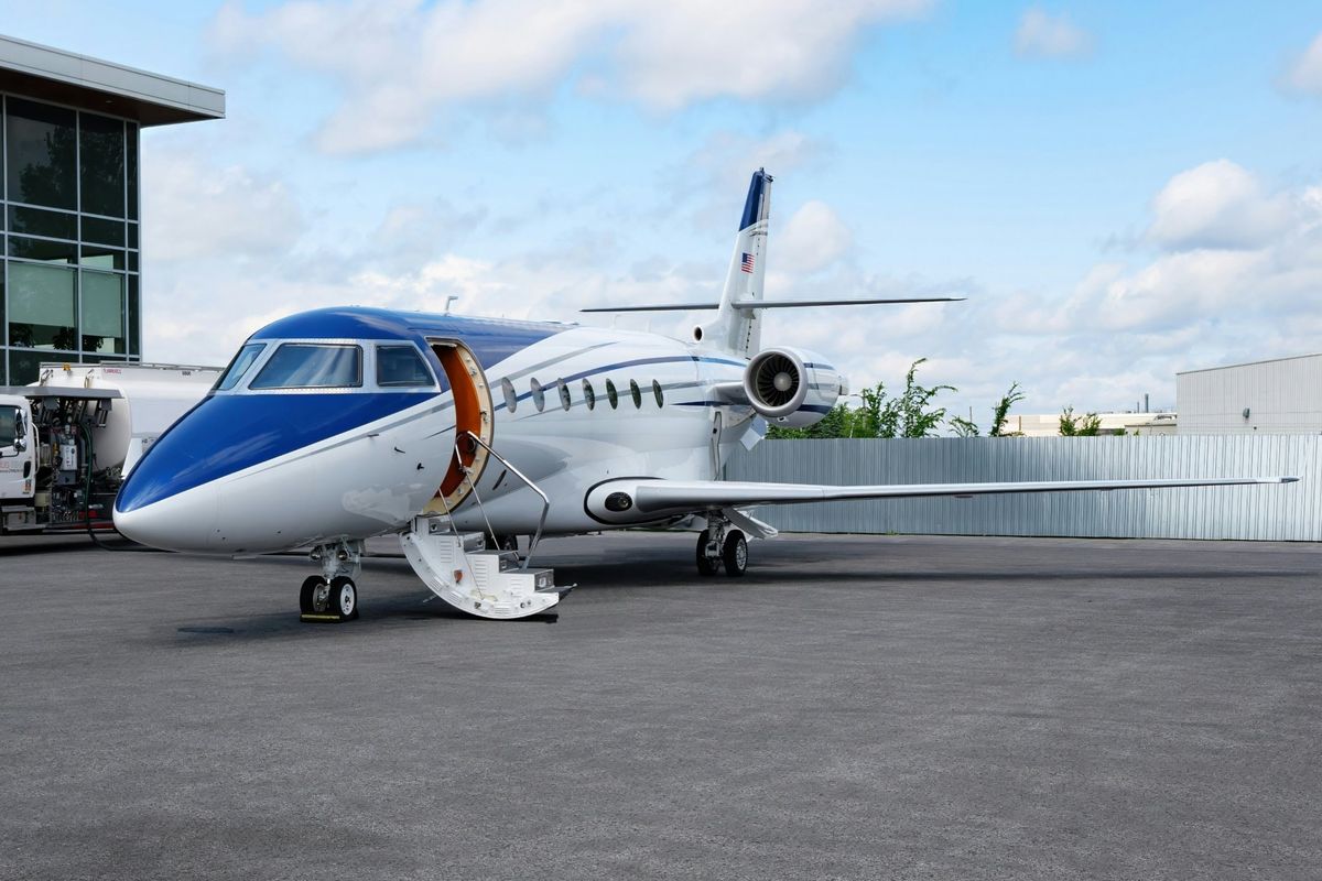 Private jet on the ramp with its airstair door open
