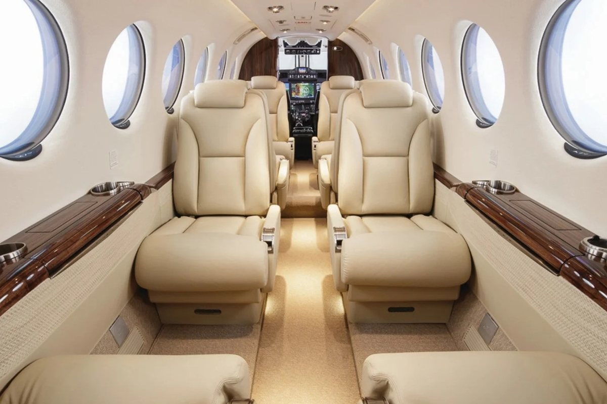 Turboprop cabin with cream leather seats and wood trim